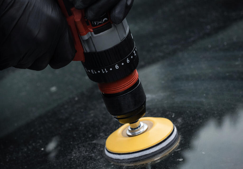 A household drill using the provided backing pad and felt pads to apply the cerium oxide polish